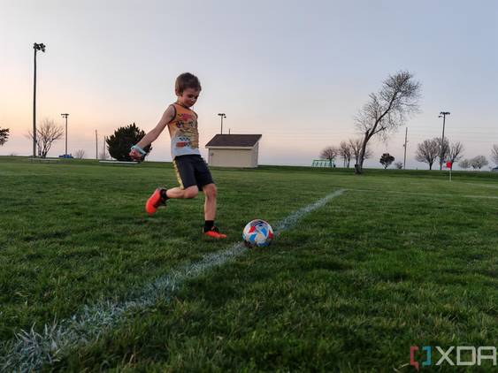 Child playing soccer photo taken using AI Motion Sense
