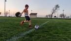 Child playing soccer photo taken using AI Motion Sense
