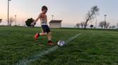 Child playing soccer photo taken using AI Motion Sense