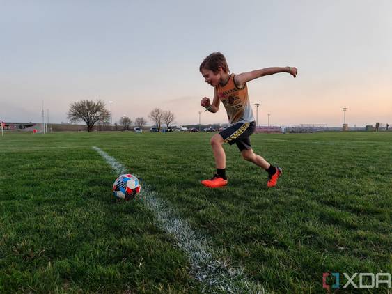 Child playing soccer photo taken using AI Motion Sense