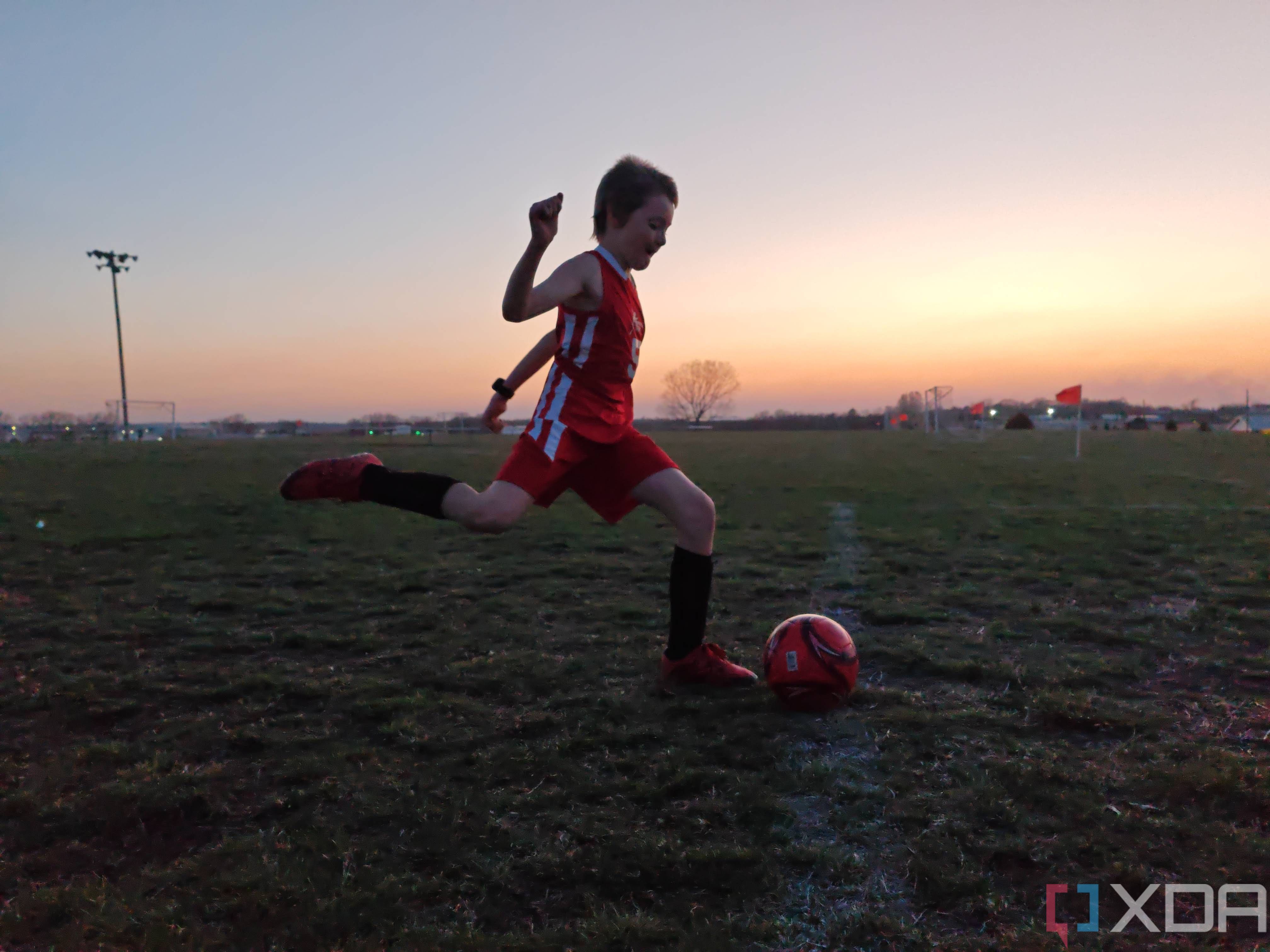 Child playing soccer photo taken using manual shutter