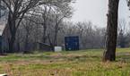 Outdoor photo of a barn and shipping container at 3.5x zoom