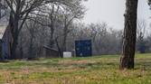 Outdoor photo of a barn and shipping container at 3.5x zoom