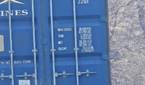 Outdoor photo of a barn and shipping container at 30x zoom