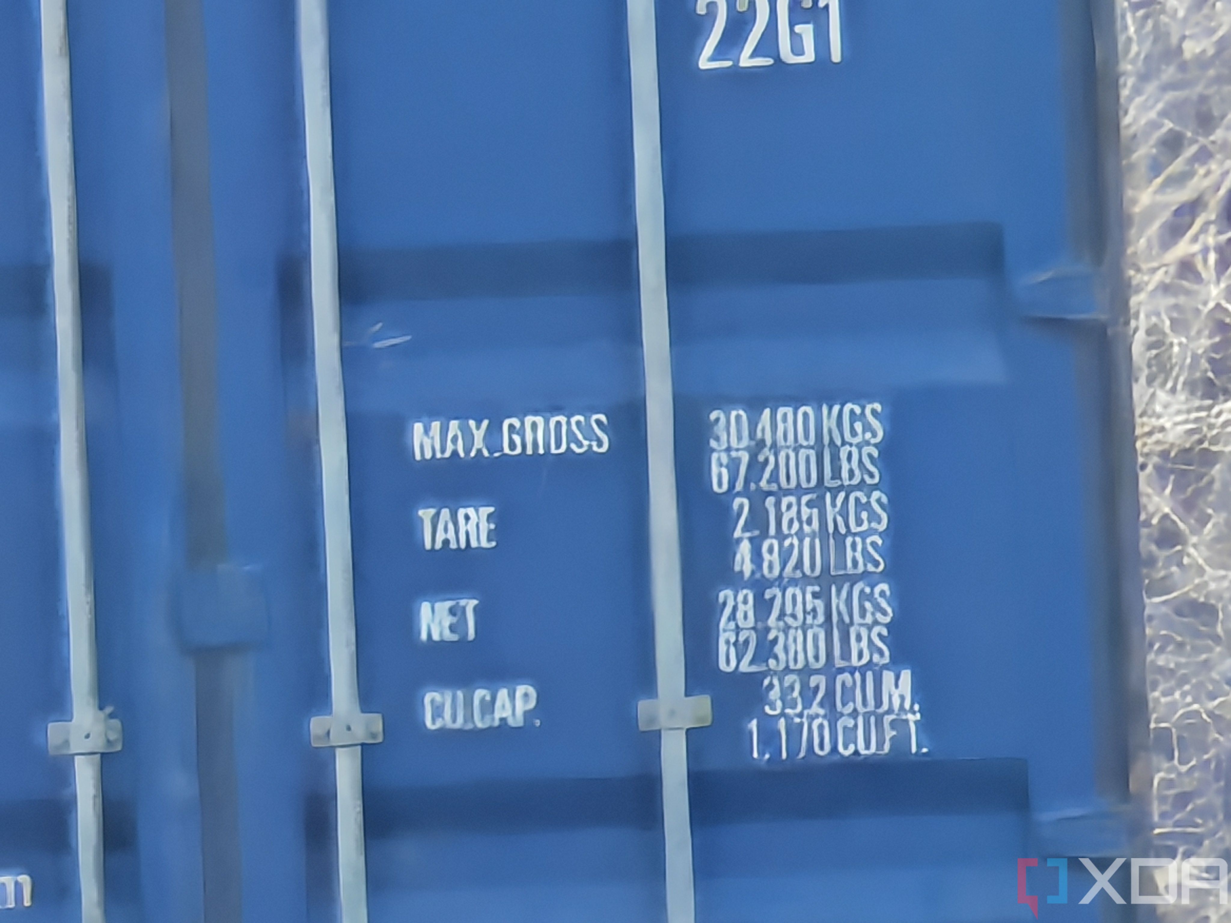 Outdoor photo of a barn and shipping container at 50x zoom