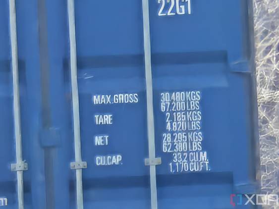 Outdoor photo of a barn and shipping container at 50x zoom