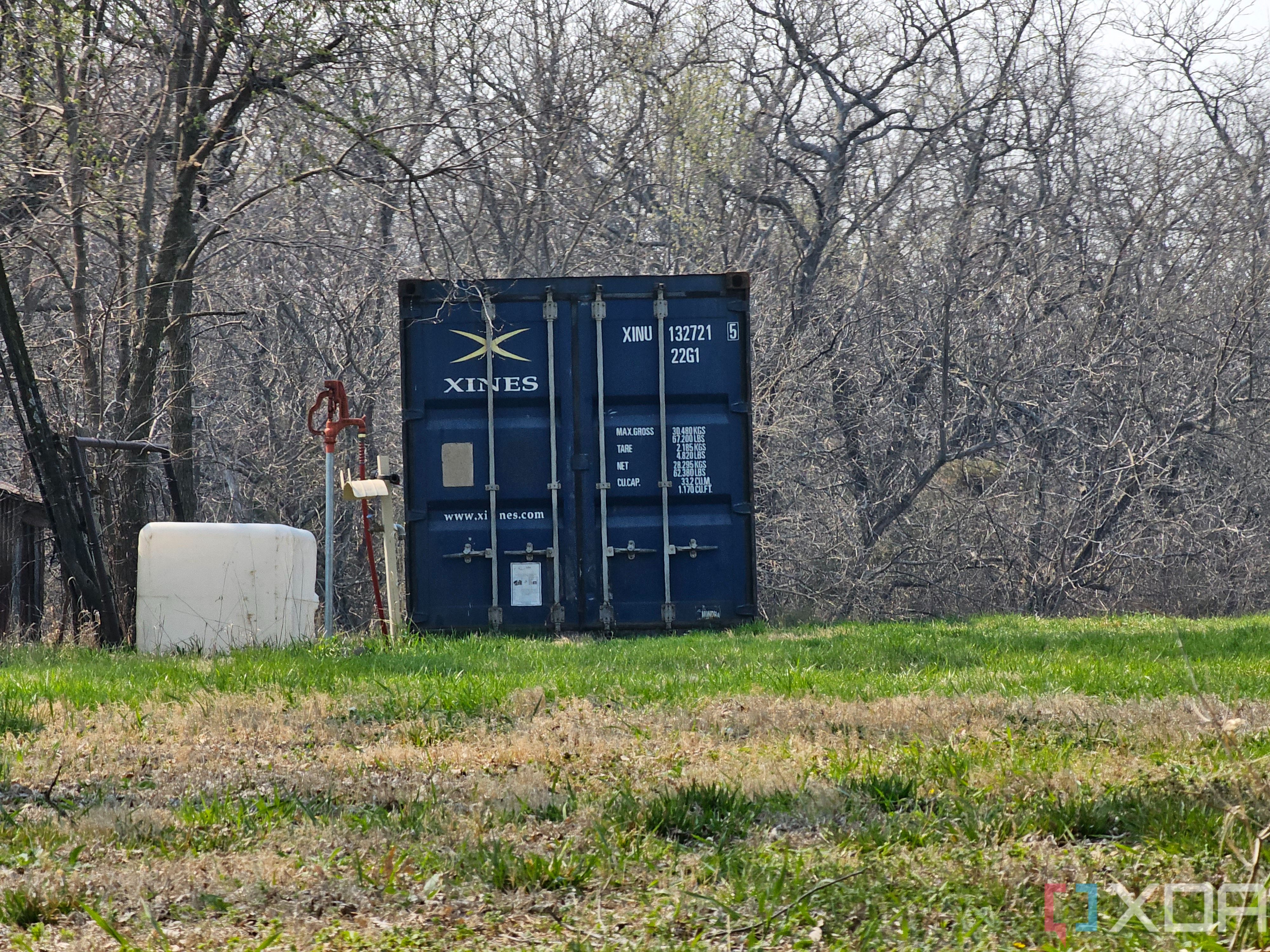 Photo of a barn and shipping container at 10x zoom