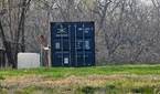 Photo of a barn and shipping container at 10x zoom