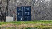 Photo of a barn and shipping container at 10x zoom