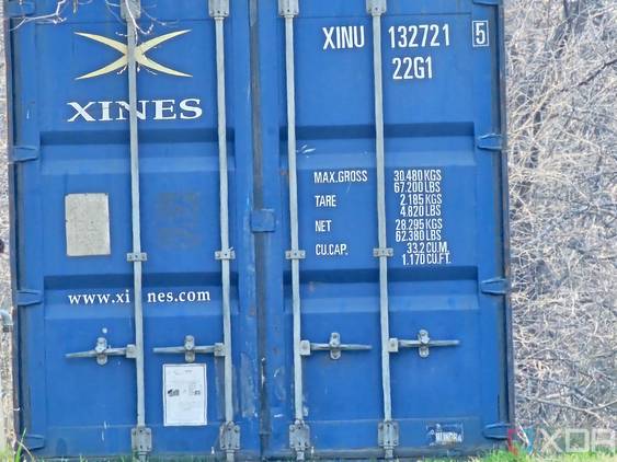 Photo of a barn and shipping container at 30x zoom