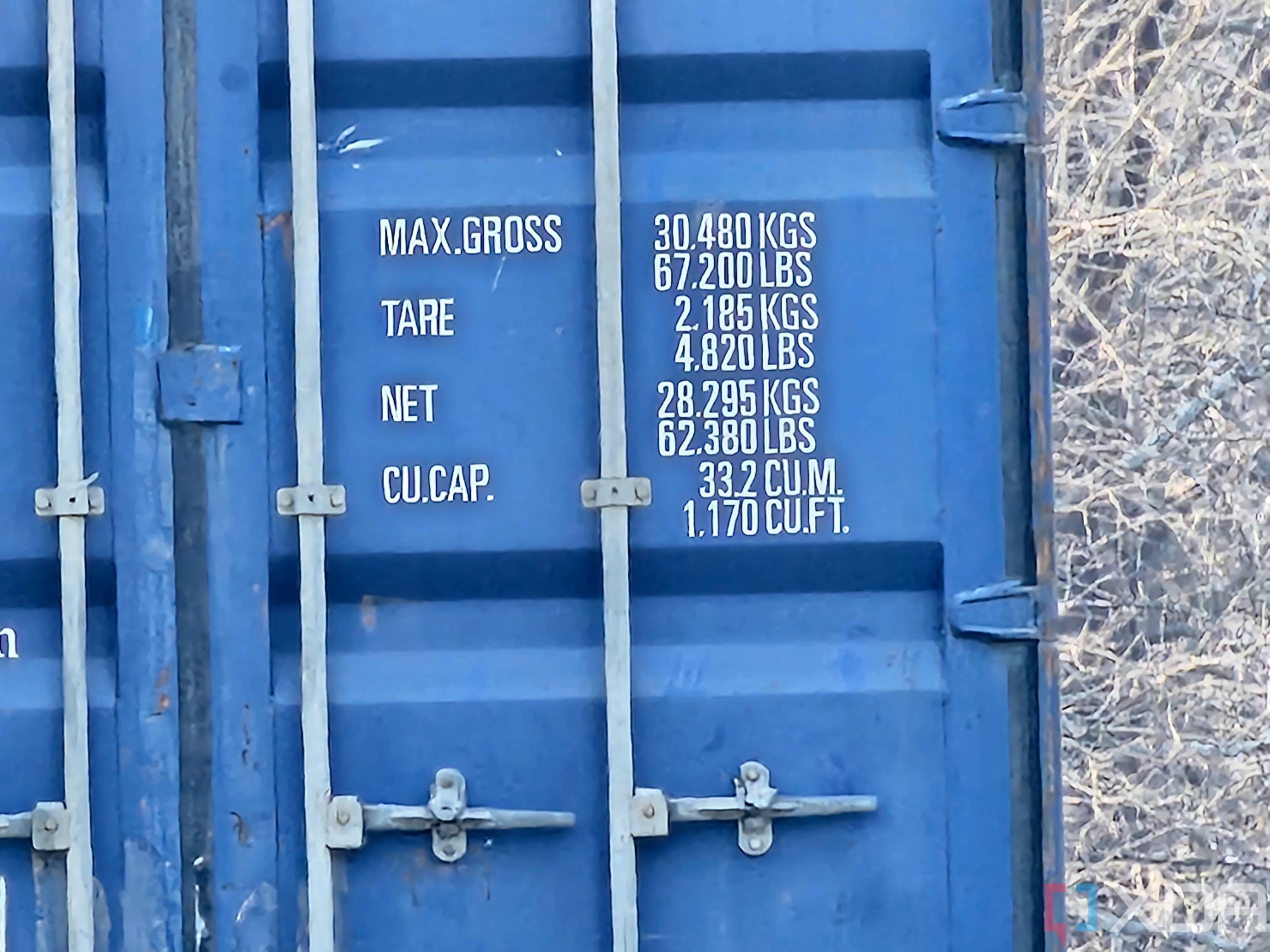 Photo of a barn and shipping container at 50x zoom