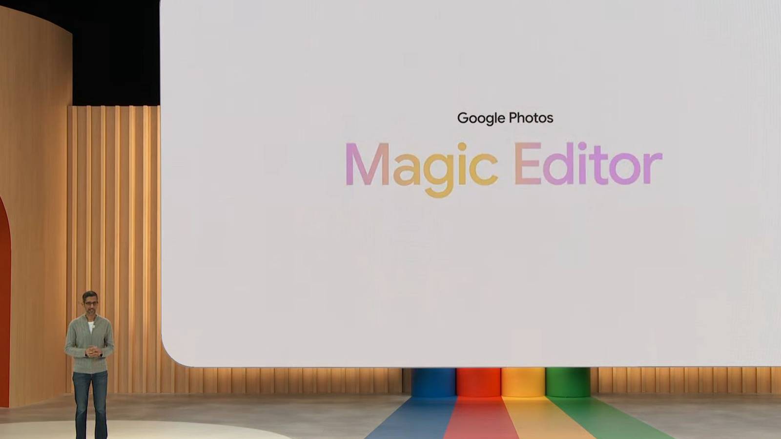 Google's Sundar Pichai at I/O 2023 next to a screen with text saying Google Photos Magic Editor.