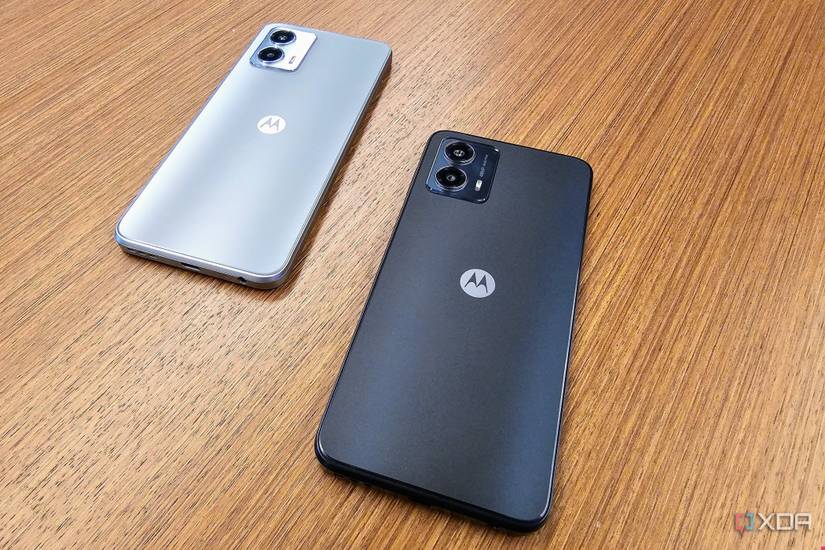 The back of the Moto G 2023 in Ink Blue and Harbor Gray on a wood table