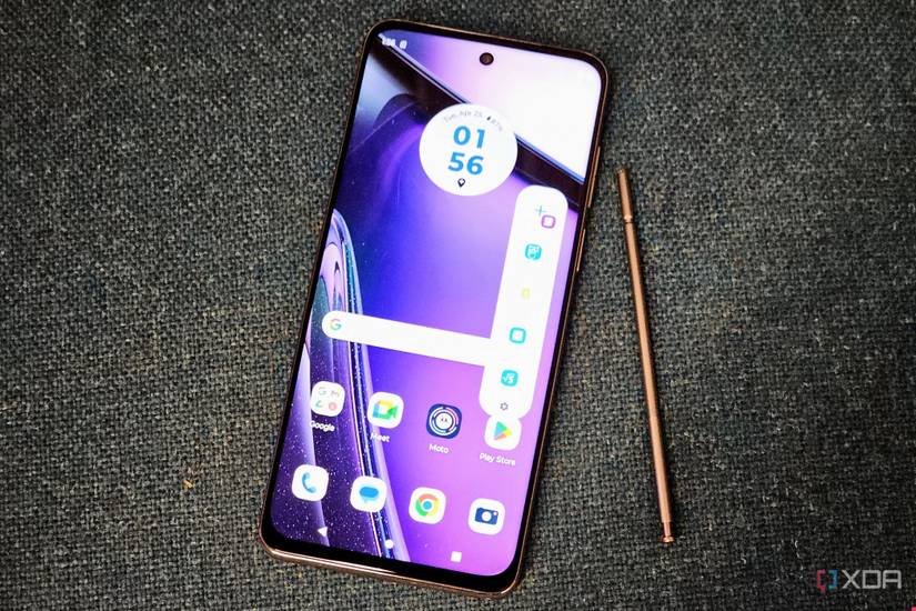 The Moto G Stylus 2023 with the stylus beside in on a gray couch