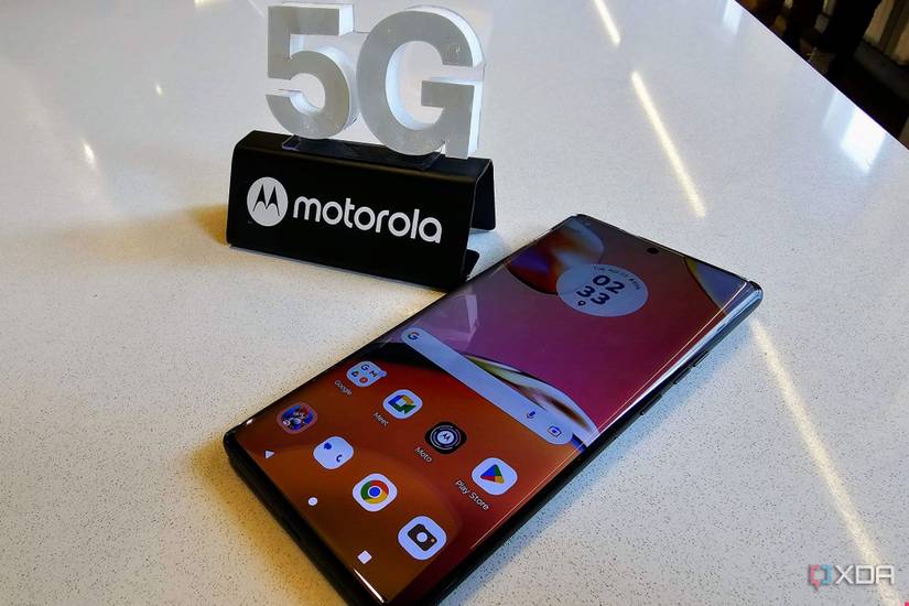 Motorola Edge+ 2023 on a white table beside a 5G Motorola sign
