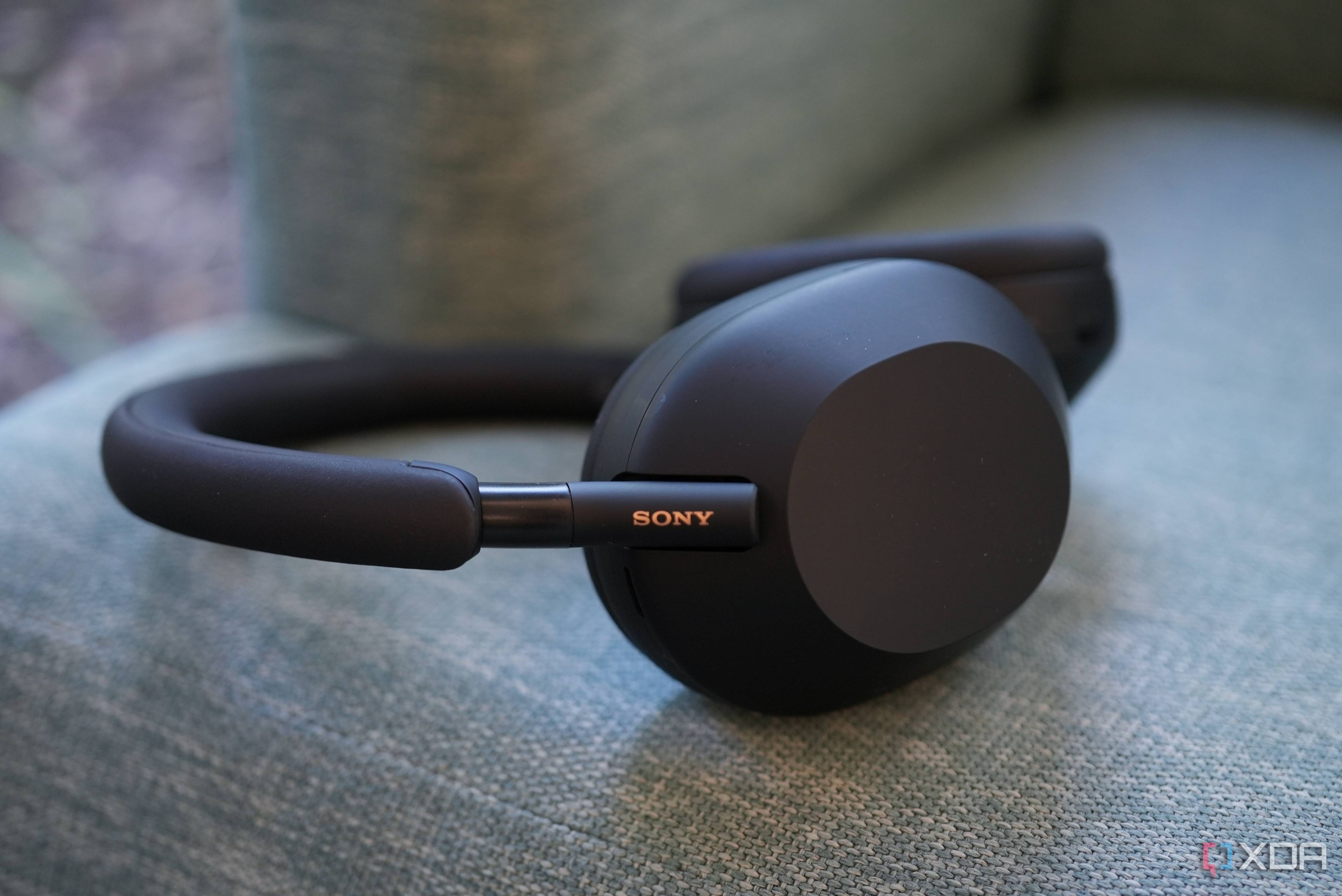 Sony WH-1000XM5 headphones on a sofa