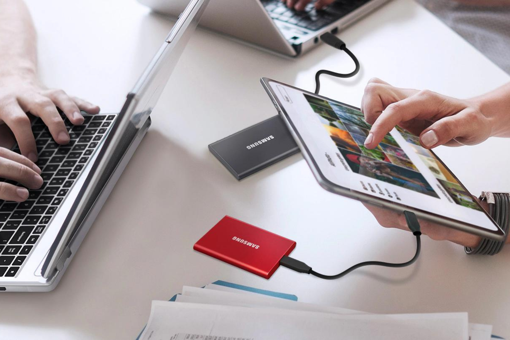 Samsung T7 SSD drive in red plugged into a tablet 