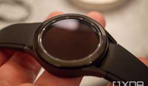A Samsung Galaxy Watch 4 Classic held in someone's fingers