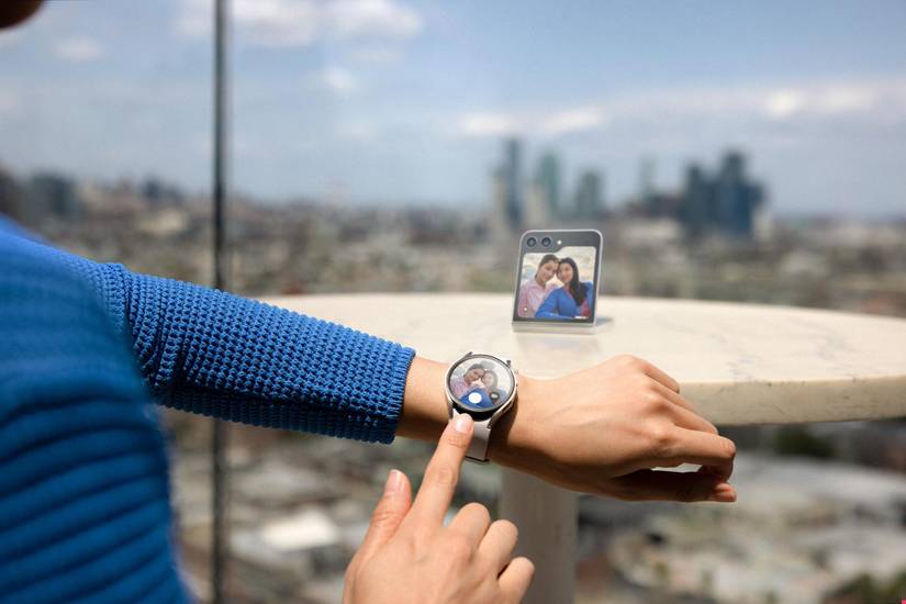 Person clicking a photo on a Galaxy Z Flip 5 using a Galaxy Watch 6.