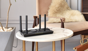 TP-Link AX1800 WiFi 6 Router on a marble table with furs in the background