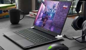 The Alienware x14 R2 on a desk next to an Alienware mouse and headphones.