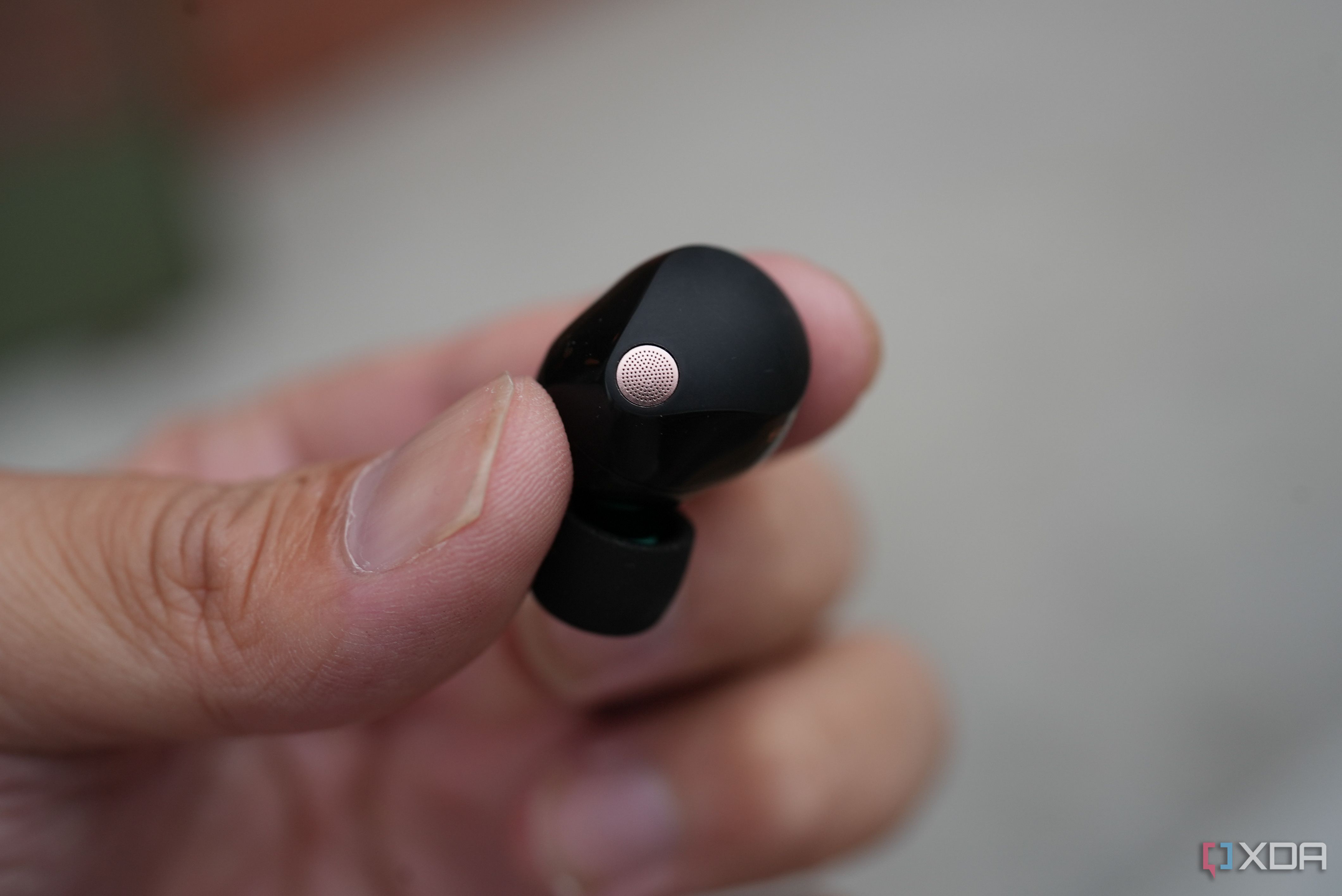 The Sony XM5 earbuds in the hand