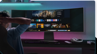 Person sitting in front of Samsung Odyssey G9 49-inch OLED monitor