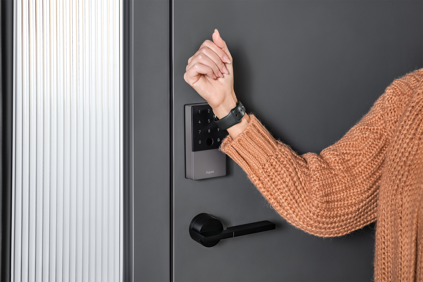 A woman opens her smart lock using her Apple Watch