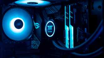 Close up of gaming PC showing fan, RAM, and CPU cooler in blue lighting