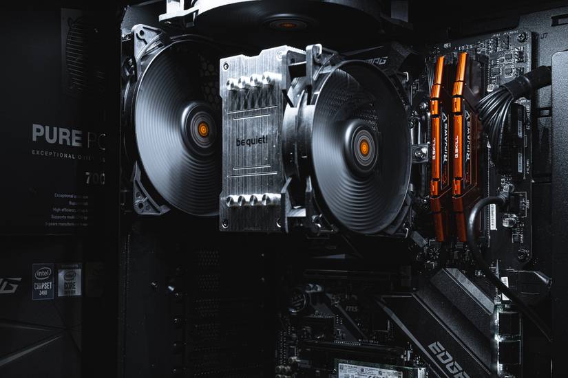Gaming PC internals showing motherboard, CPU cooler, and RAM
