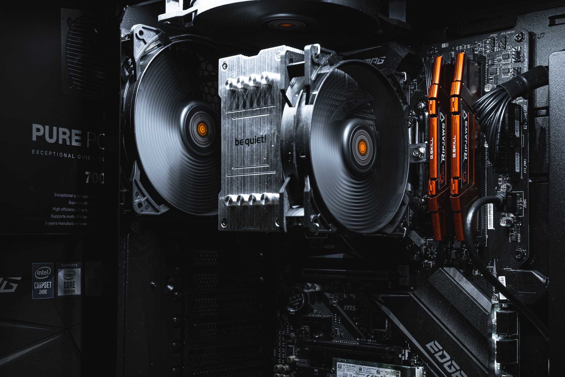 Gaming PC internals showing motherboard, CPU cooler, and RAM