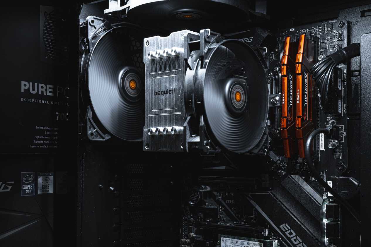 Gaming PC internals showing motherboard, CPU cooler, and RAM