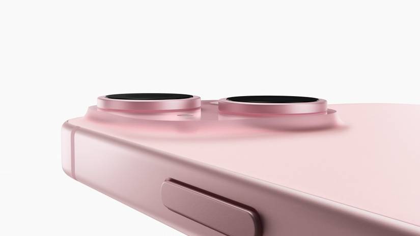 A pink iPhone 15 showing a close-up of the back camera area and the side button.