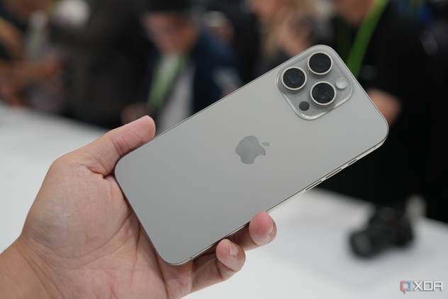 Holding an iPhone 15 Pro Max in Natural Titanium colorway