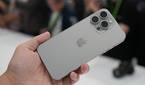 Holding an iPhone 15 Pro Max in Natural Titanium colorway