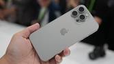 Holding an iPhone 15 Pro Max in Natural Titanium colorway