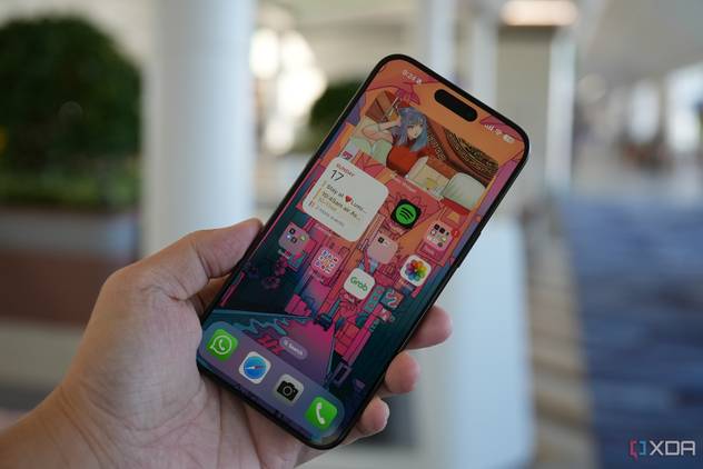 The iPhone 15 Pro Max in the hand with the screen on.