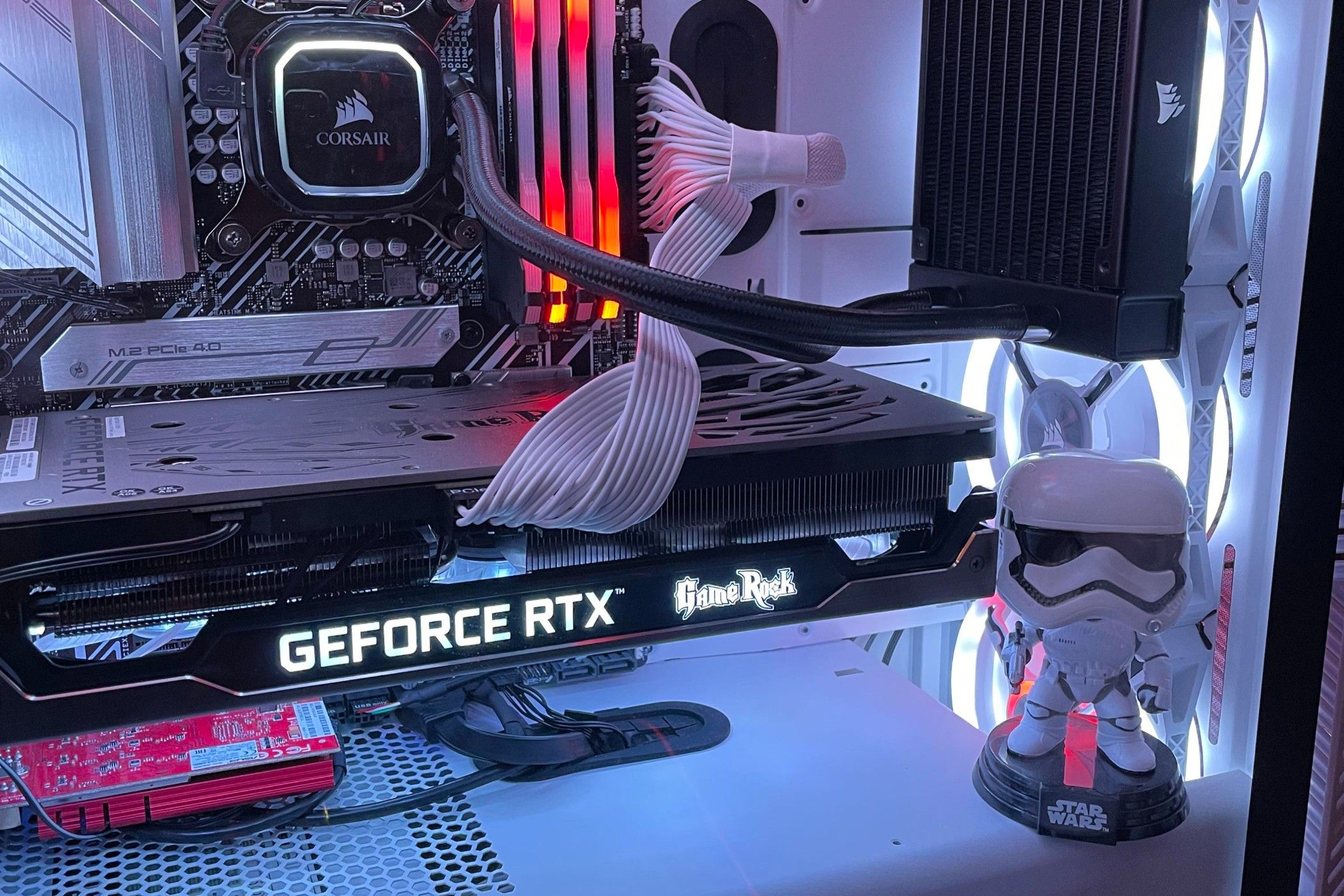 Stormtrooper action figure inside gaming PC with lights.