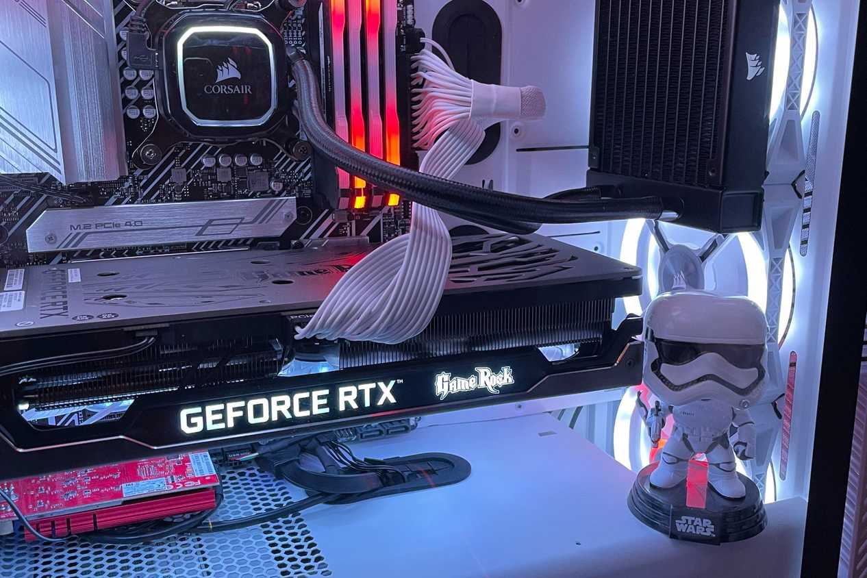 Stormtrooper action figure inside gaming PC with lights.
