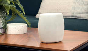 Motorola Q14 Mesh WiFi 6E Router on the coffee table next to a plant