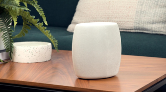 Motorola Q14 Mesh WiFi 6E Router on the coffee table next to a plant