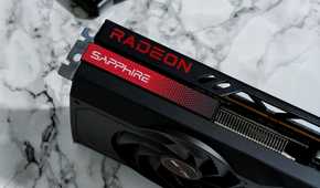 An image showing an AMD Radeon RX 7700 XT GPU kept on a desk with a marble finish.