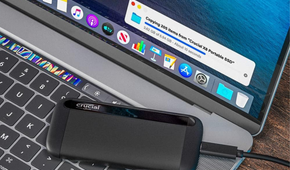 Crucial X8 4TB Portable SSD on top of laptop transferring data