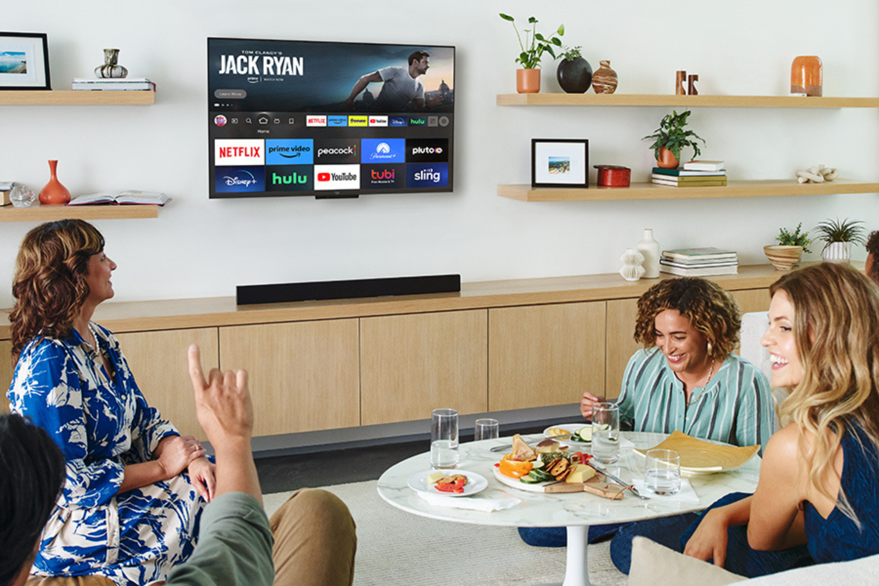 People watching Toshiba 55-inch Class C350 Series LED 4K UHD Smart Fire TV in living room having fun and laughing