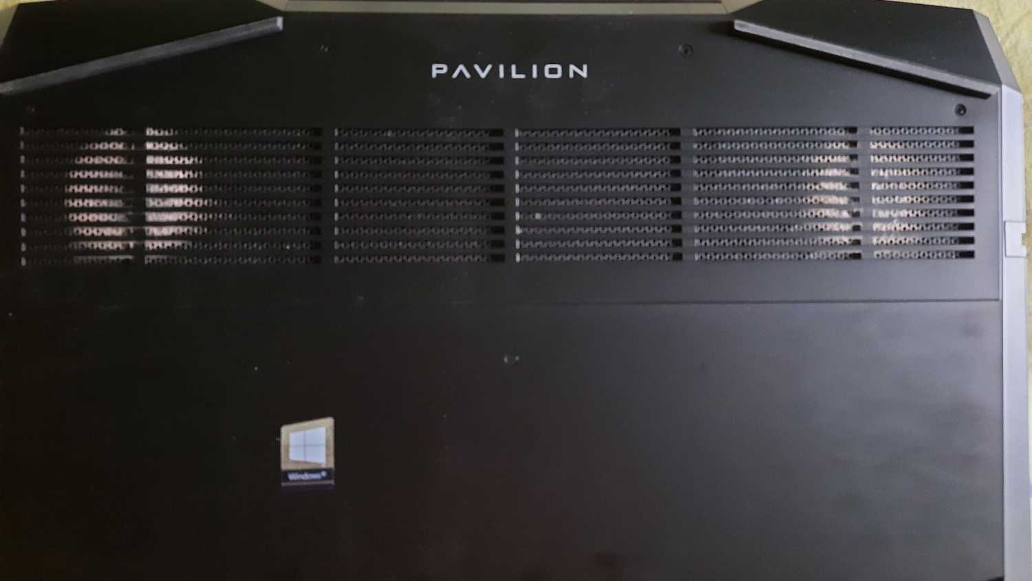 An image showing a laptop with dust buildup on the vents on its back