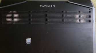 An image showing a laptop with dust buildup on the vents on its back