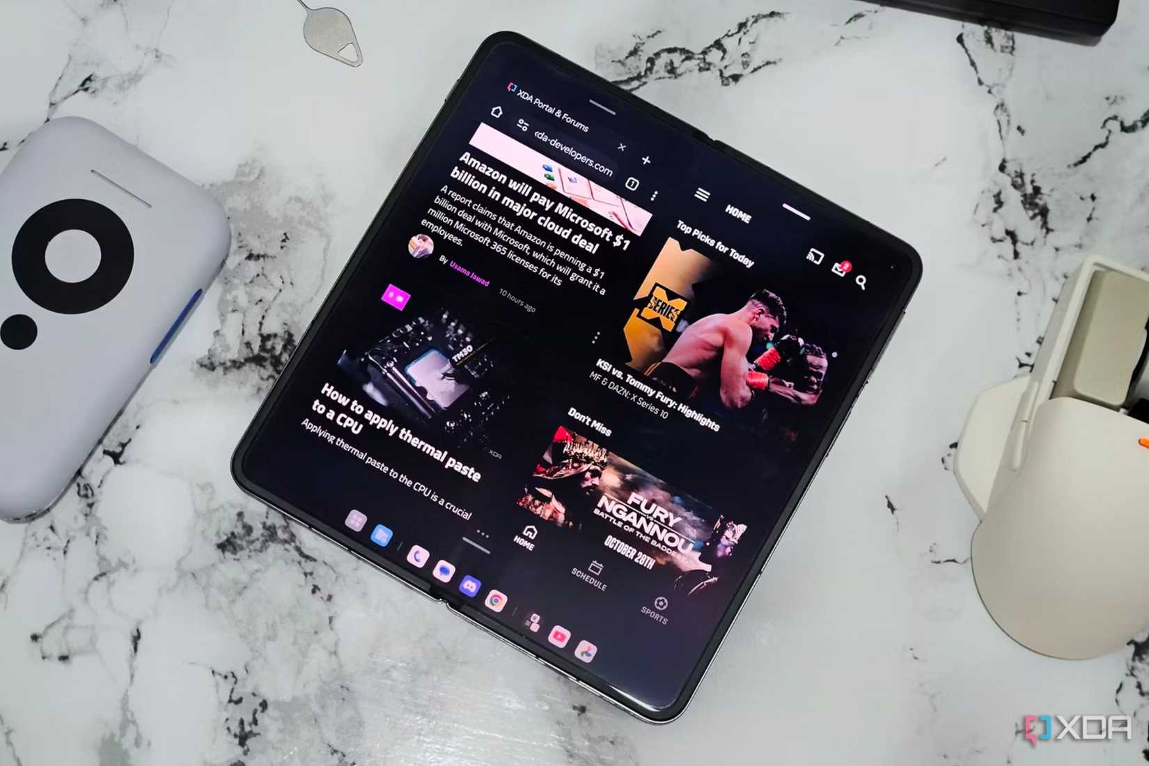An image showing a OnePlus Open kept on a table displaying two app side-by-side.