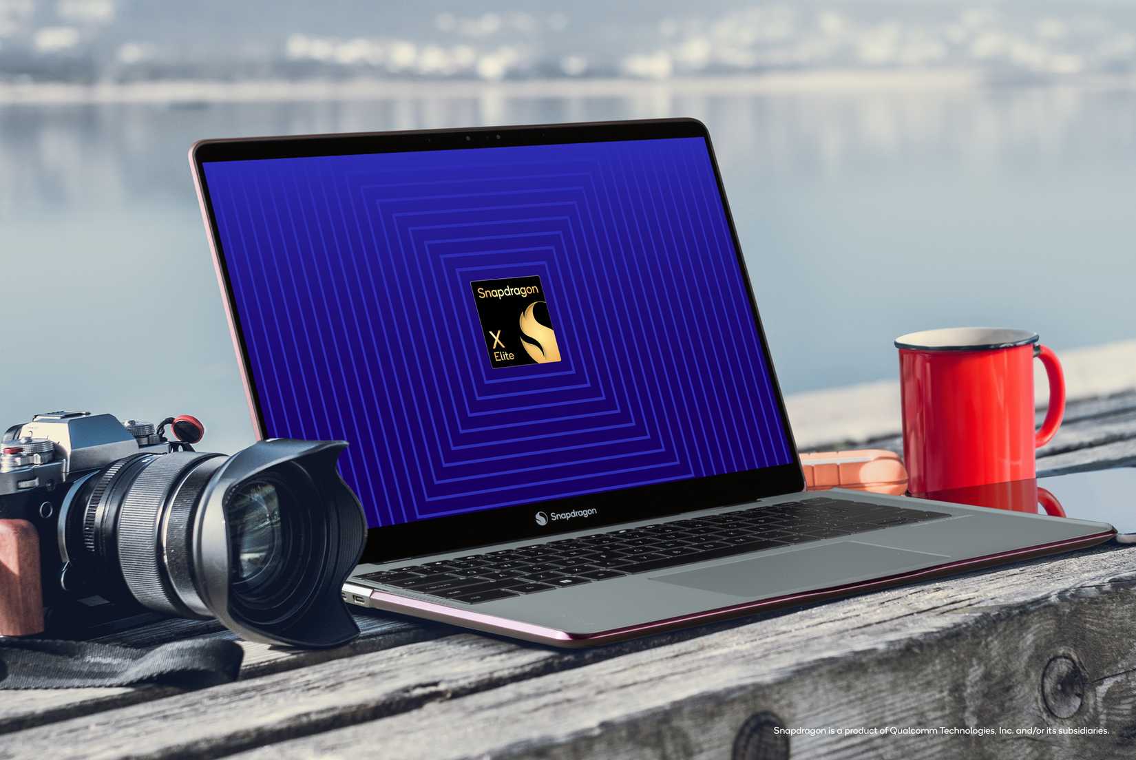 Snapdragon X Elite next to camera and mug