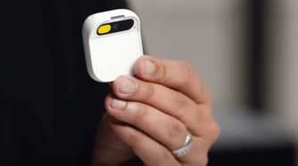 A person holding the Humane AI Pin.
