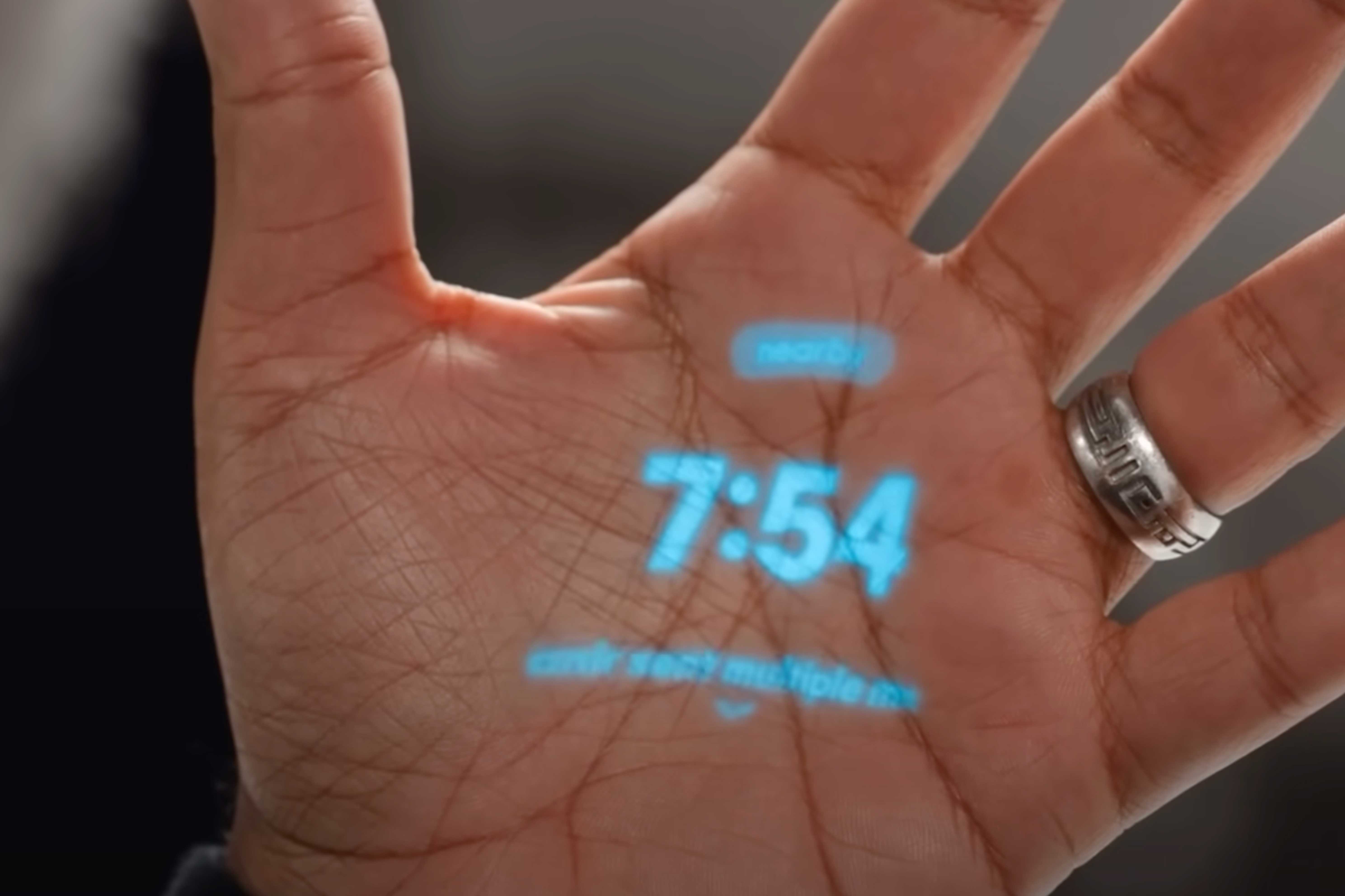 The Humane AI Pin's laser display on a hand.